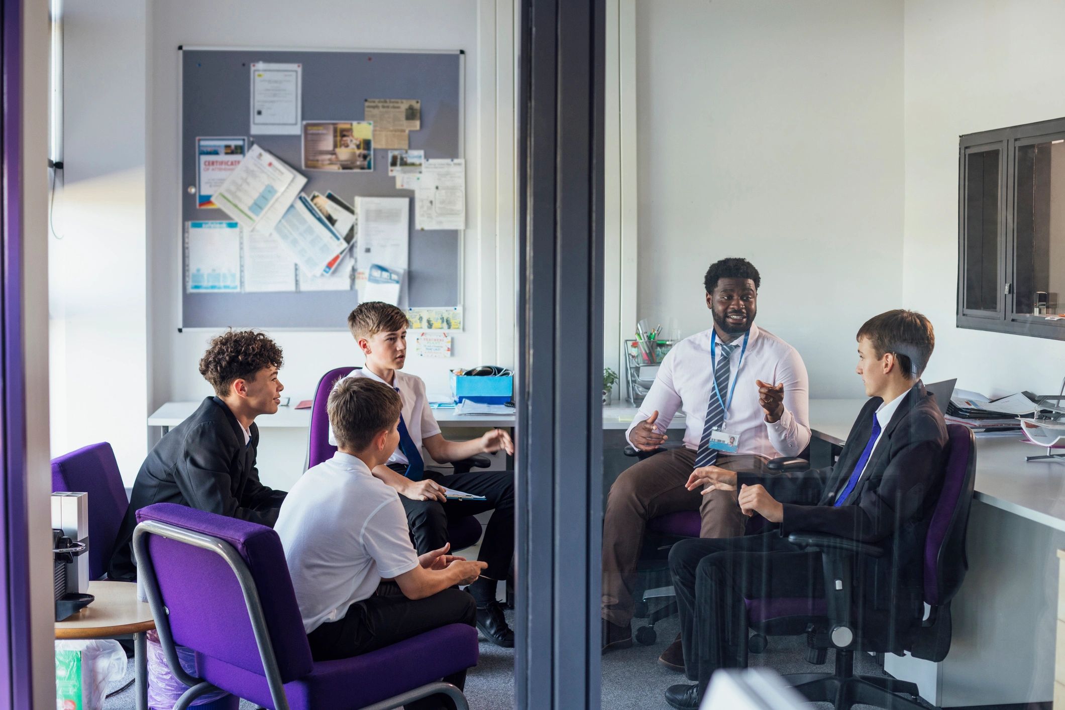 Teacher speaking with students in a small group setting